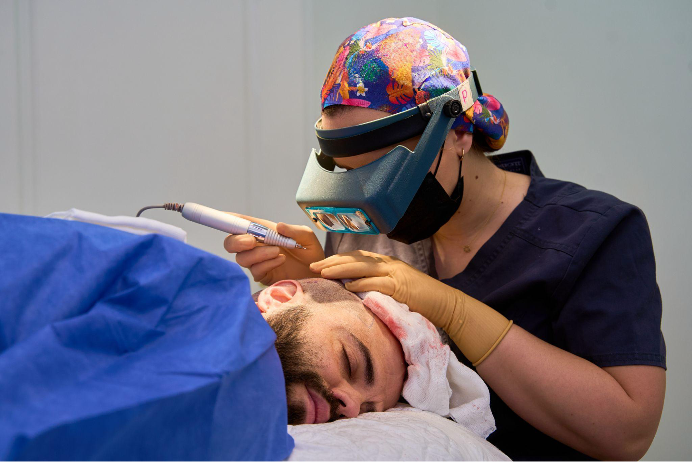 A doctor performs a minimally invasive hair restoration procedure using advanced tools and modern techniques.