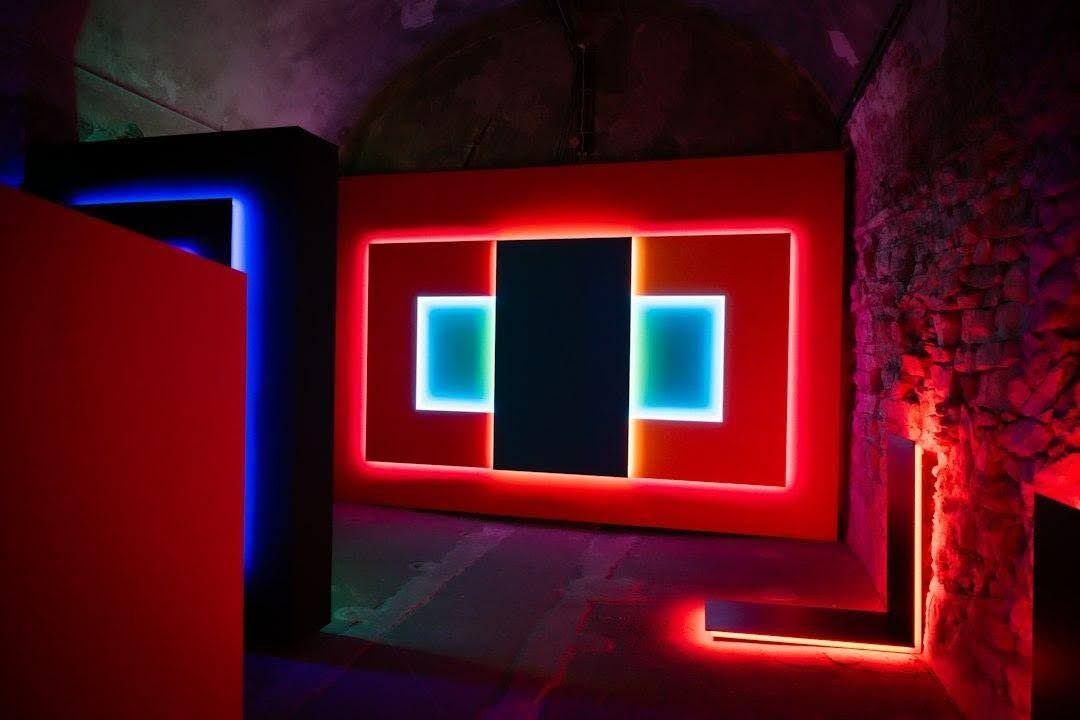 Modern art installation with red and blue neon lights