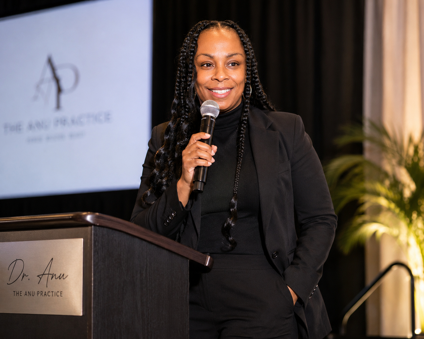 Dr. Anu speaking at a professional event