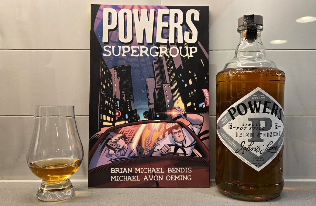 Powers 12 year old John's Lane Irish whisky and the trade paperback of Powers Supergroup