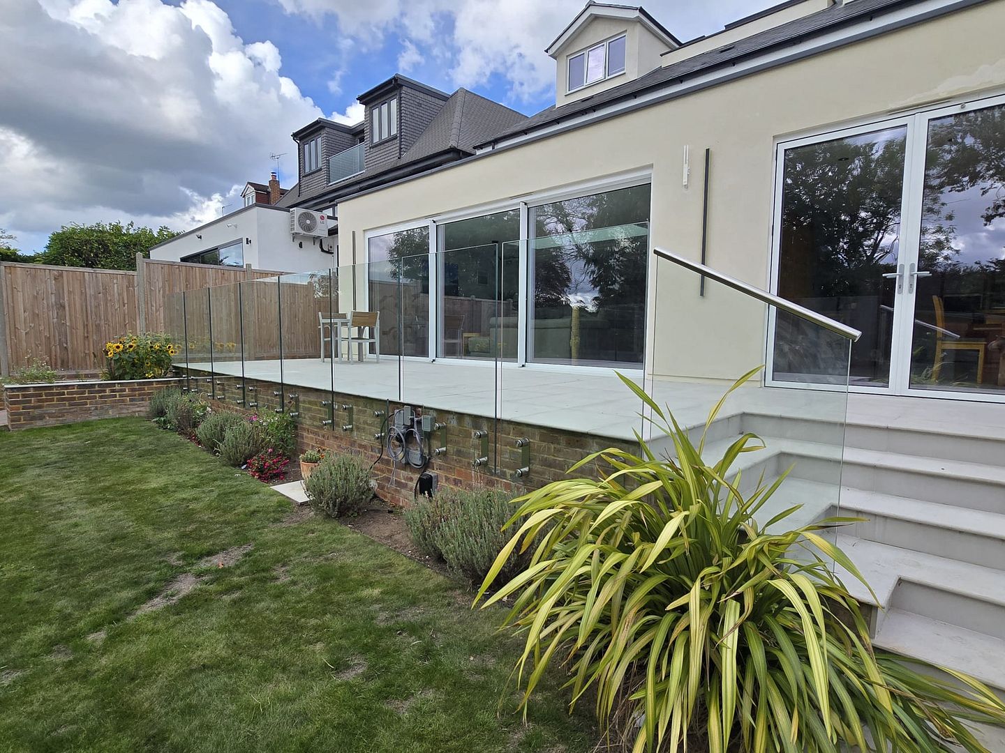 Low patio glass balcony installation