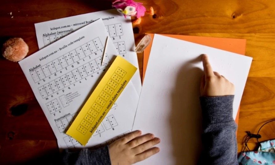 Jeune homme apprend le braille