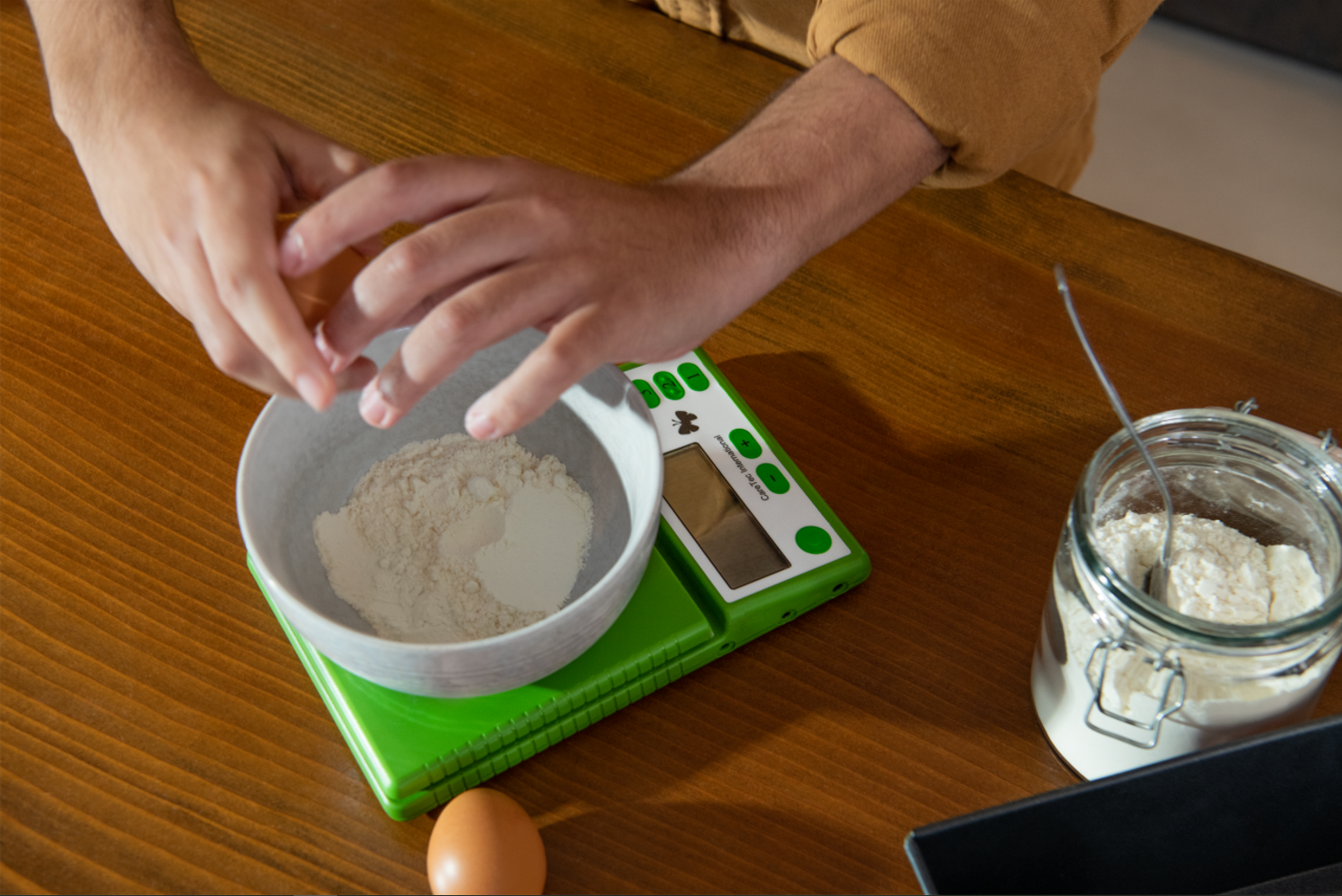 Un homme utilise la balance parlante Heidi pour cuisiner