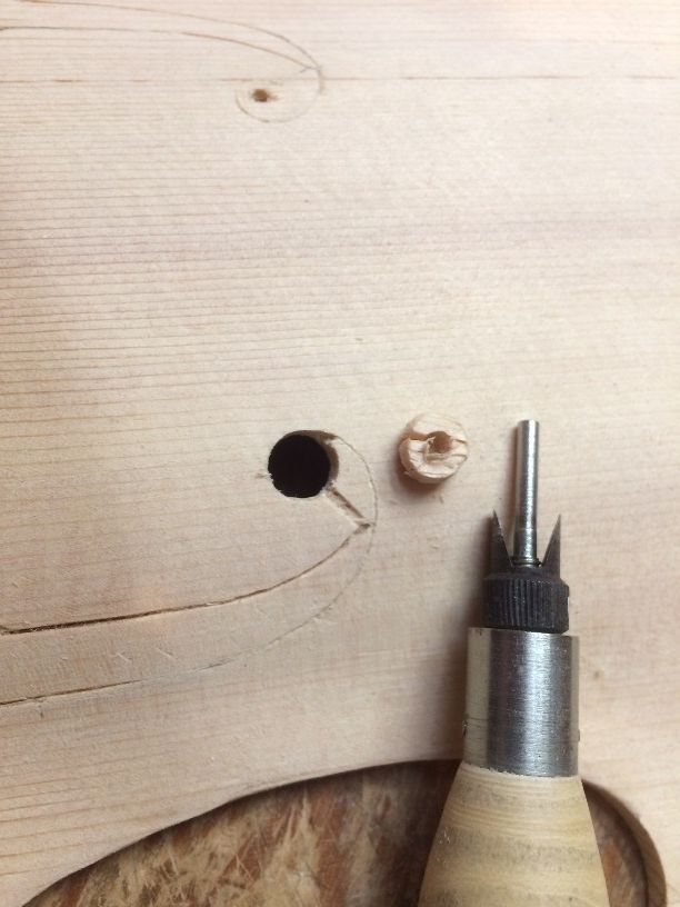 F-hole cutter with plug removed from a Five String viola front plate.