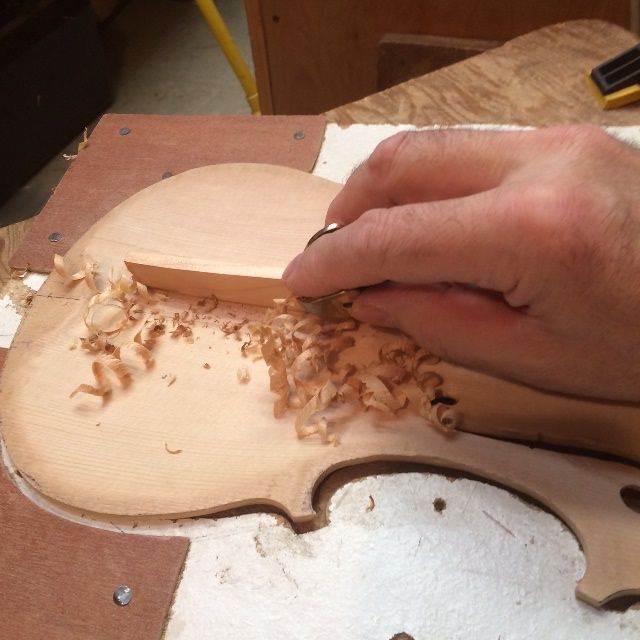 Shaping the bass-bar in a Five-string viola, using a finger-plane.
