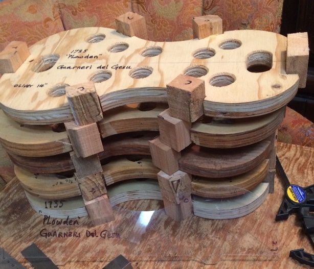 5-string fiddle molds with blocks and a transparent template.