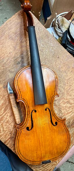 Completed five-string fiddle ready for retouching.