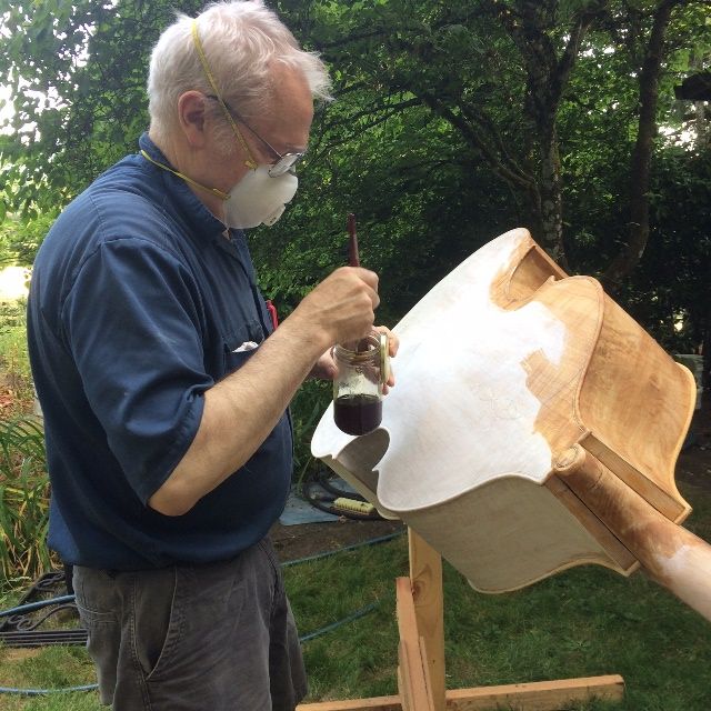Sealing the back plate of a five-string double bass.