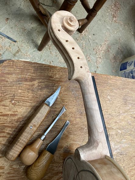 final carving of the neck and heel of a 5-string bluegrass fiddle handcrafted in Oregon by artisanal luthier Chet Bishop
