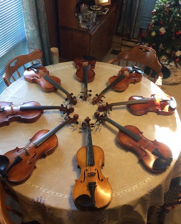Dining table display of violins.