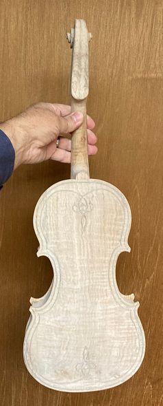 Back plate of five string fiddle with dry mineral ground. Handcrafted in Oregon, by Chet Bishop, artisanal luthier.