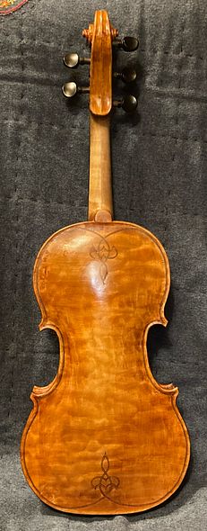 Quilted maple back of a 5-string bluegrass fiddle, handcrafted in Oregon by artisanal luthier, Chet Bishop.