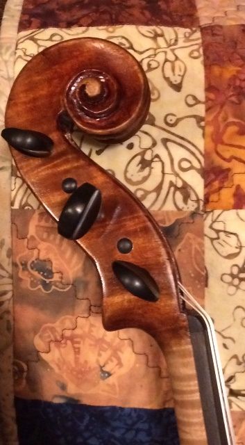 Scroll of handmade 5-string bluegrass fiddle by Chet Bishop.