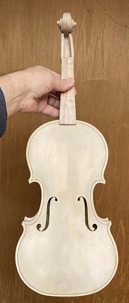 Front view of five string fiddle in gypsum, ready for varnishing.