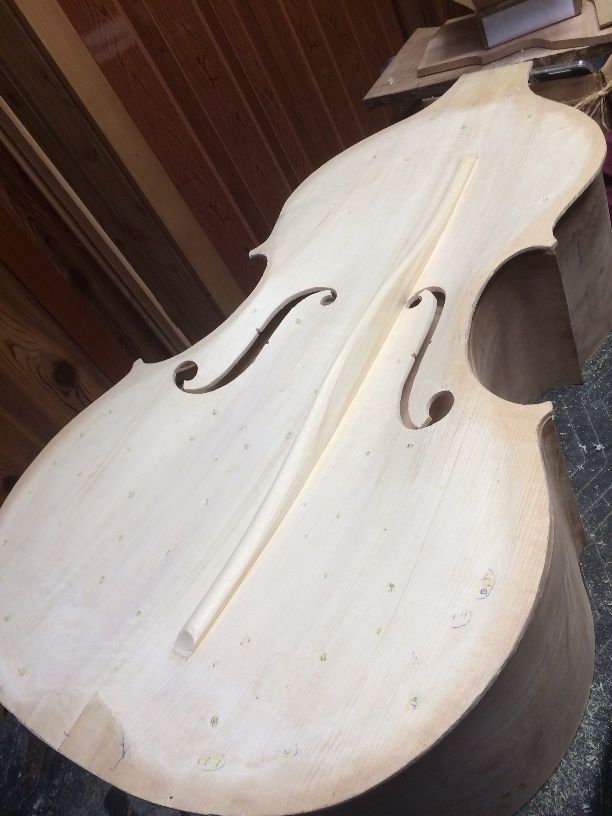 Interior of completed Front plate sitting on the garland of a five-string double bass.