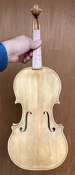 Front of five string fiddle with rosin sealer applied