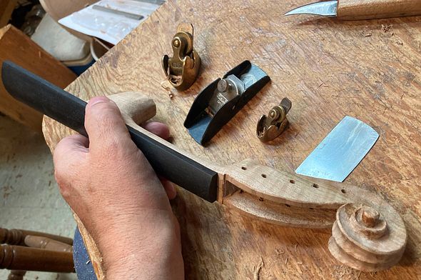 shaping fingerboard and neck on a five string fiddle by Chet Bishop, Luthier.