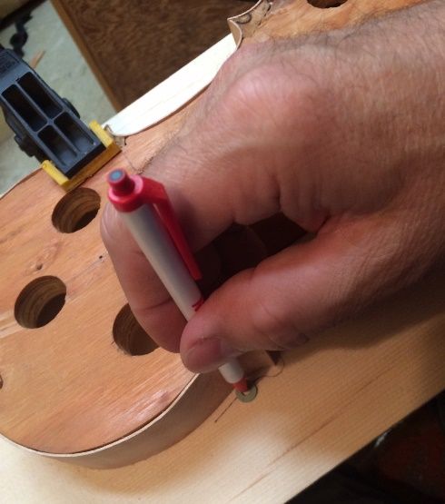tracing the front plate for a 5-string bluegrass fiddle handmade in Oregon by Chet Bishop
