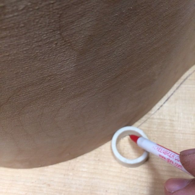 Using a pipe spacer to trace the shape of the five-string double bass front plate.