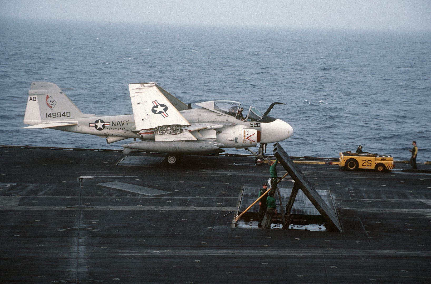 A KA 6D Intruder Aircraft Is Towed By An MD 3A Tow Tractor Aboard The Aircraft Carrier USS AMERICA