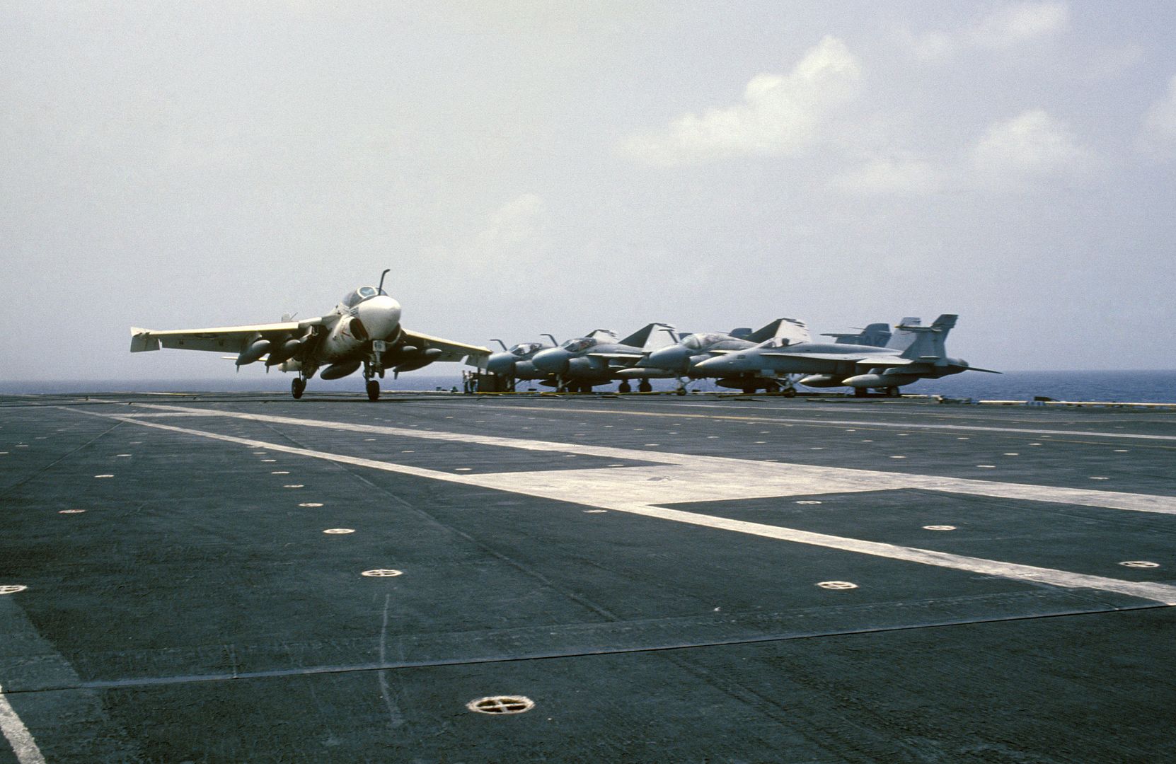  Parked At The Deck Edge Are Several A 6E Intruders And An FA 18A Hornet Aircraft