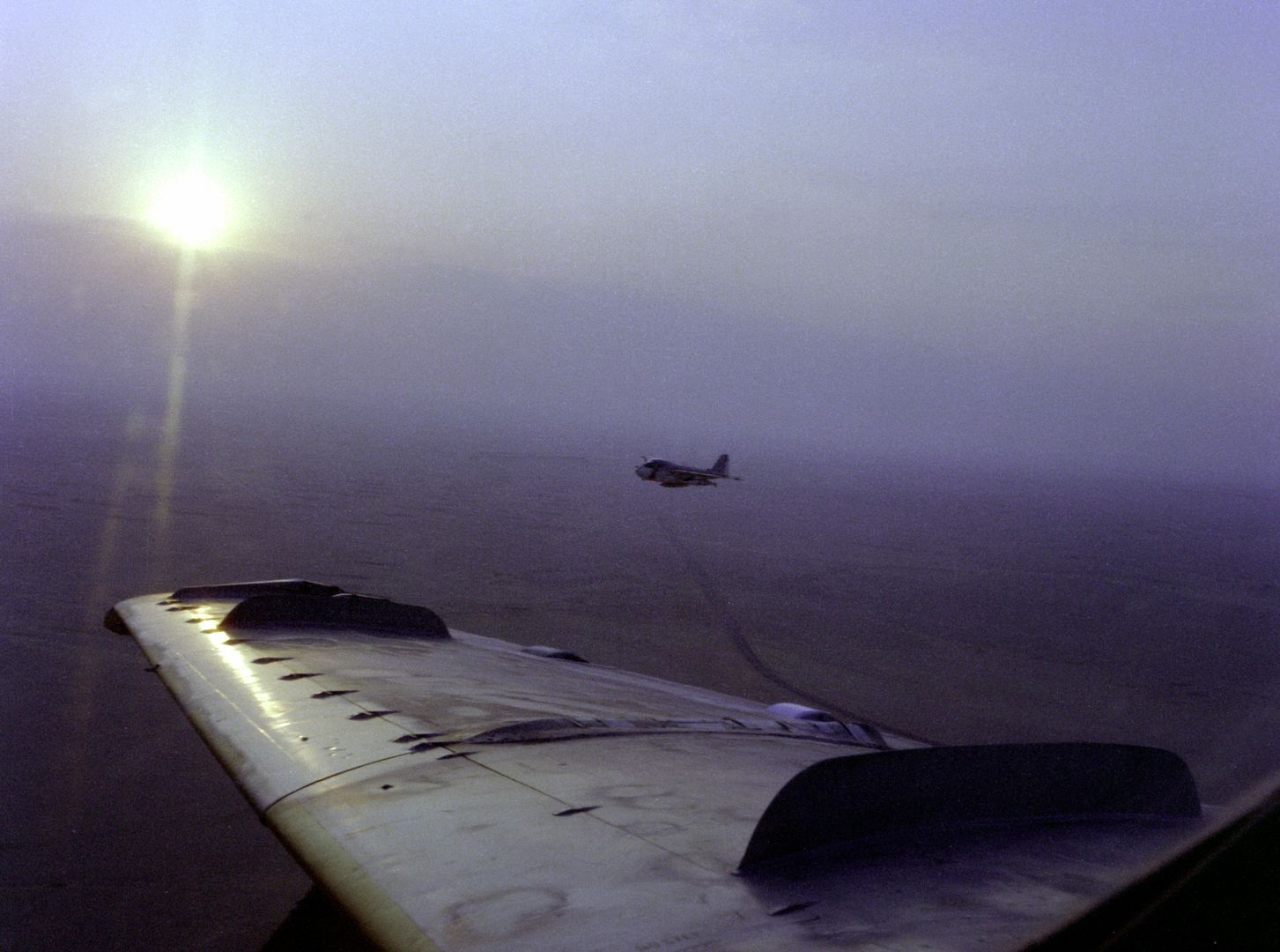 A Left Side View Of An A 6E Intruder Aircraft In Flight Off The Wing Of Another Aircraft In The Morning Sun