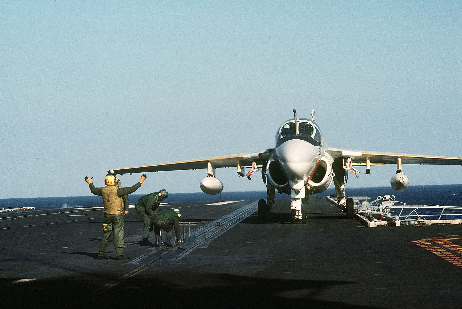 A Plane Director Aboard The Aircraft Carrier USS MIDWAY Guides An A 6E Intruder Aircraft Onto A Catapult 1