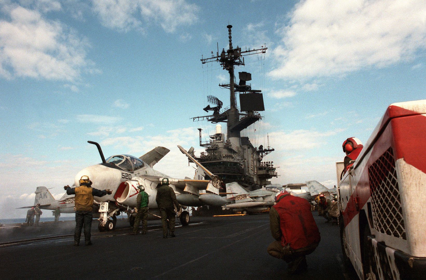 A Plane Director Guides An A 6E Intruder Aircraft Into Position On A Catapult During Flight Operations Aboard The Aircraft Carrier USS CORAL SEA