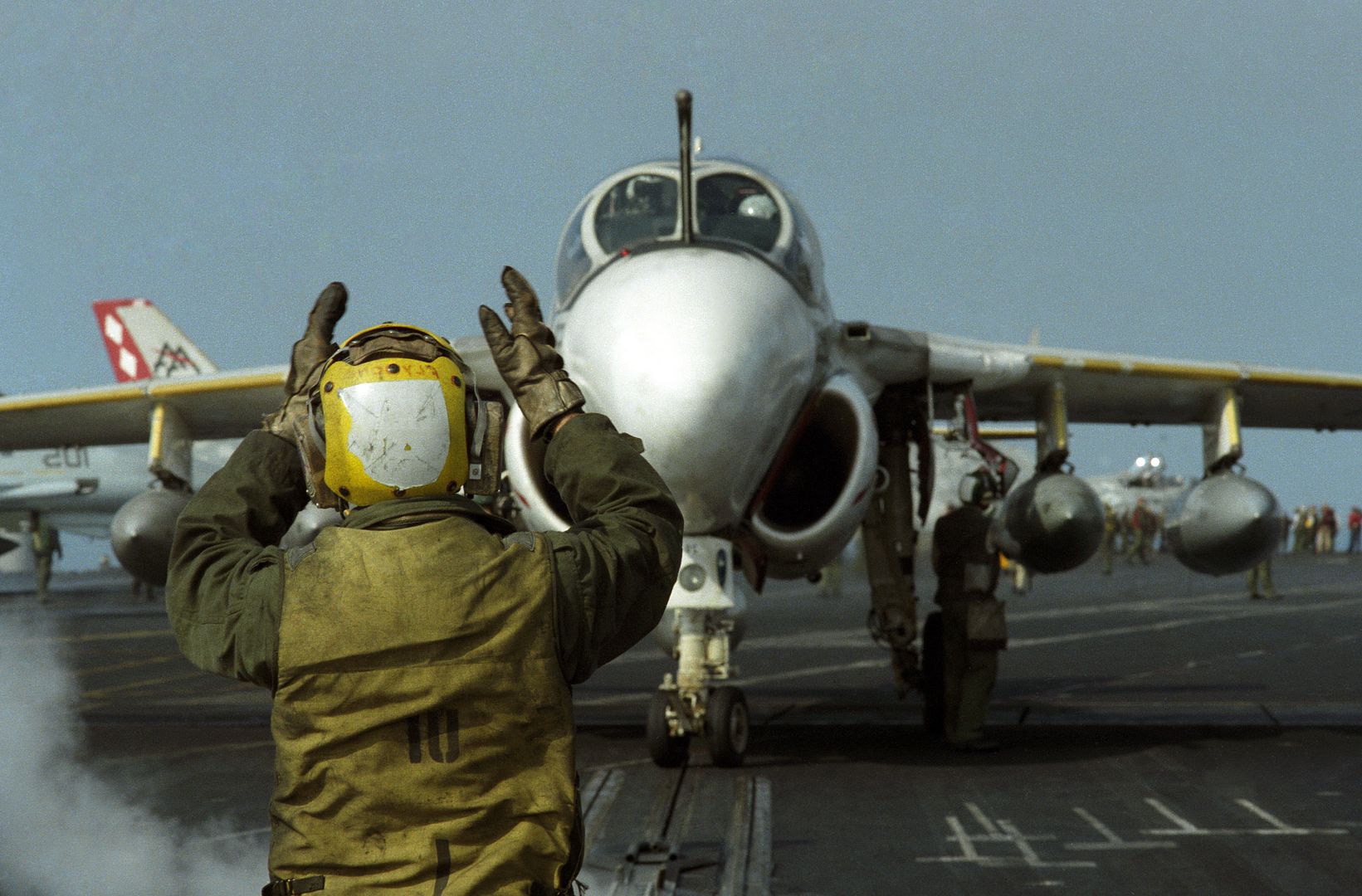 A Plane Director Guides An A 6E Intruder Aircraft Into Position Over A Catapult On The Flight Deck Of The Aircraft Carrier USS SARATOGA