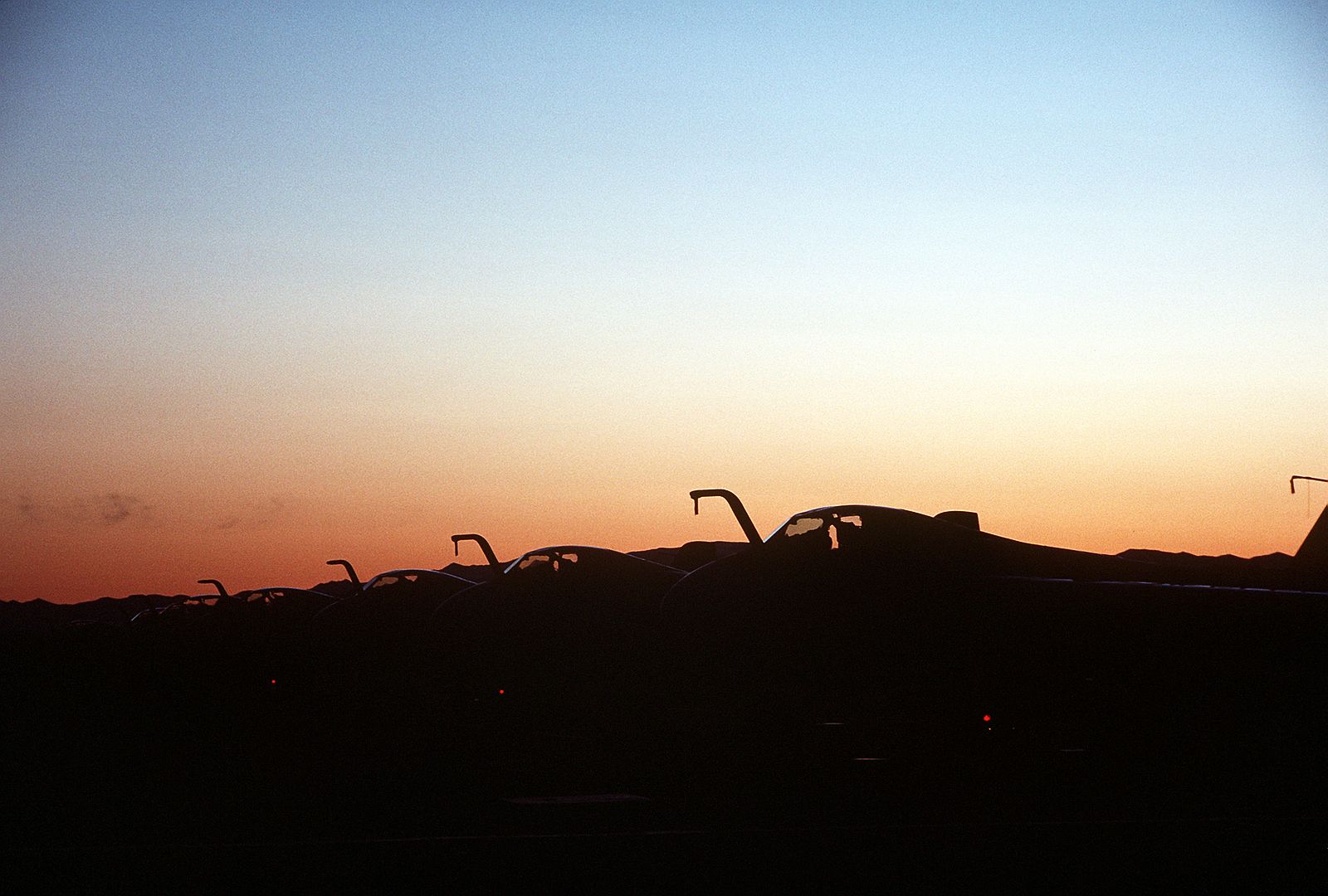 A Silhouetted Left Front View Of A 6E Intruder Aircraft From Carrier Air Wing Six Parked On The Flight Line