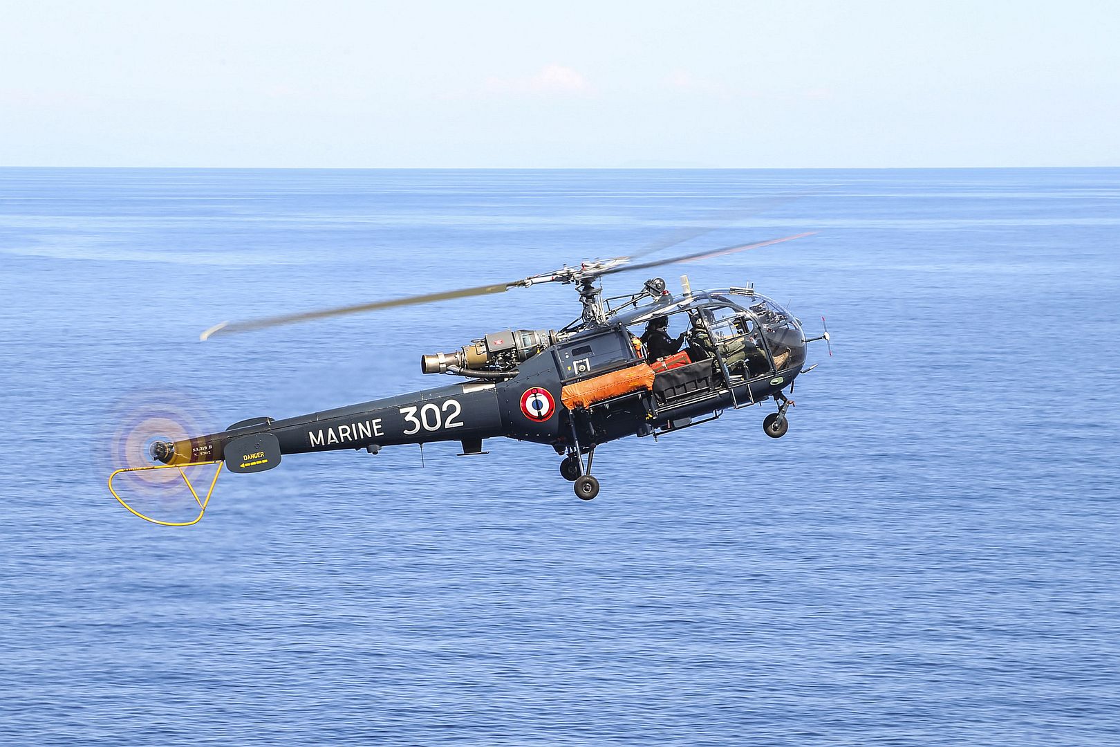 Alouette III Helicopter Prepares To Land Aboard The Amphibious Assault Ship USS Bataan