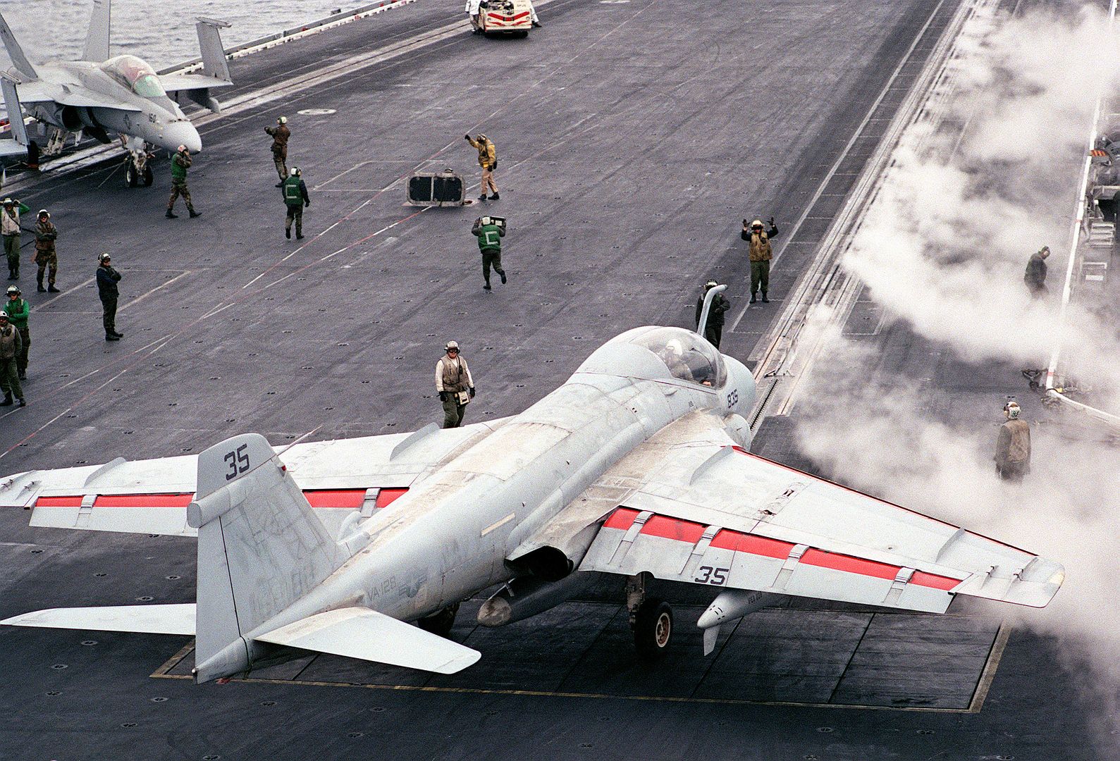 An Attack Squadron 128 A 6E Intruder Aircraft Lines Up On A Catapult For Launch As Steam Clears From A Previous Launch On The Flight Deck Of The Aircraft Carrier USS RANGER