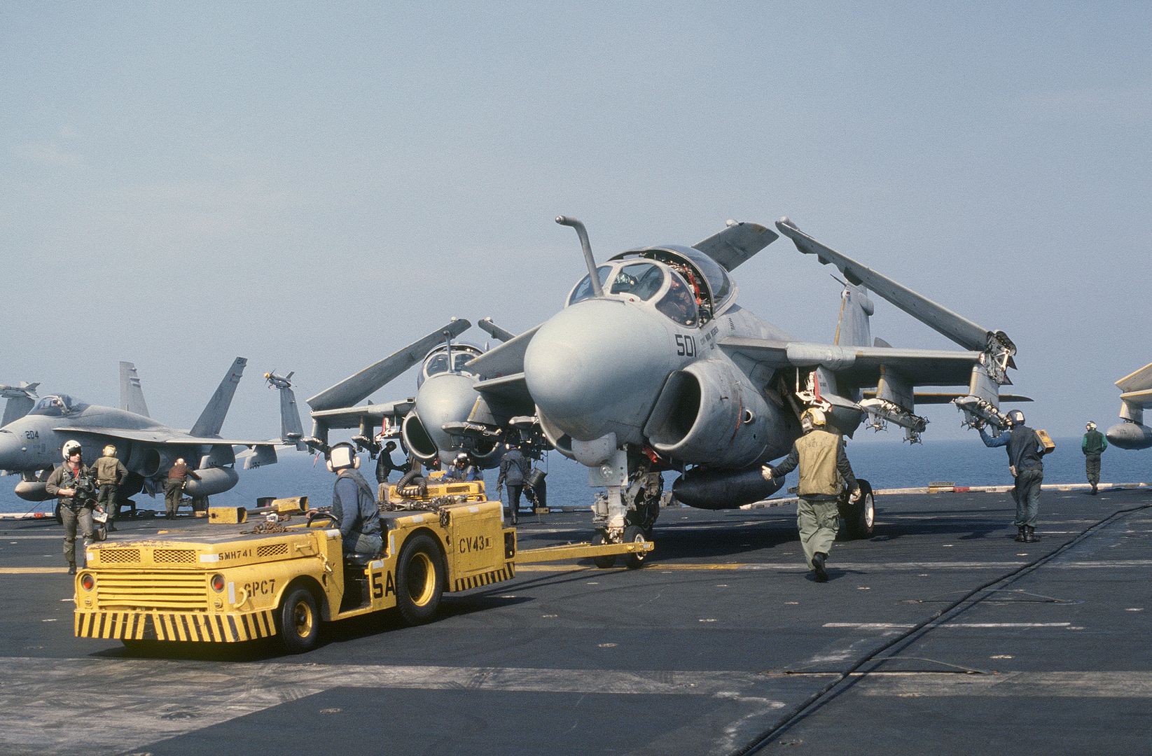 An MD 3A Tow Tractor Is Used To Park An A 6E Intruder Aircraft On The Flight Deck Aboard The Aircraft Carrier USS CORAL SEA During Flight Operations Off The Coast Of Libya