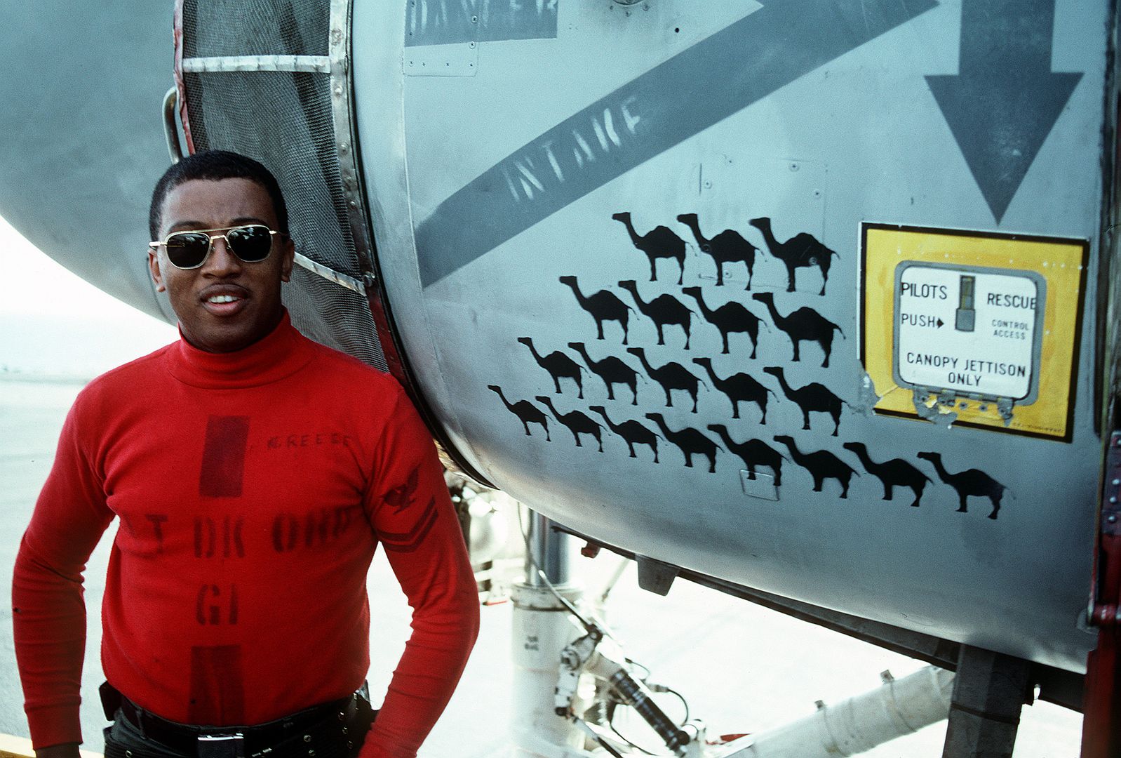 An Aviation Ordnanceman Stands Next To The Mission Markings Painted On The Side On An A 6E Intruder Aircraft On The Flight Deck Of The Aircraft Carrier USS RANGER
