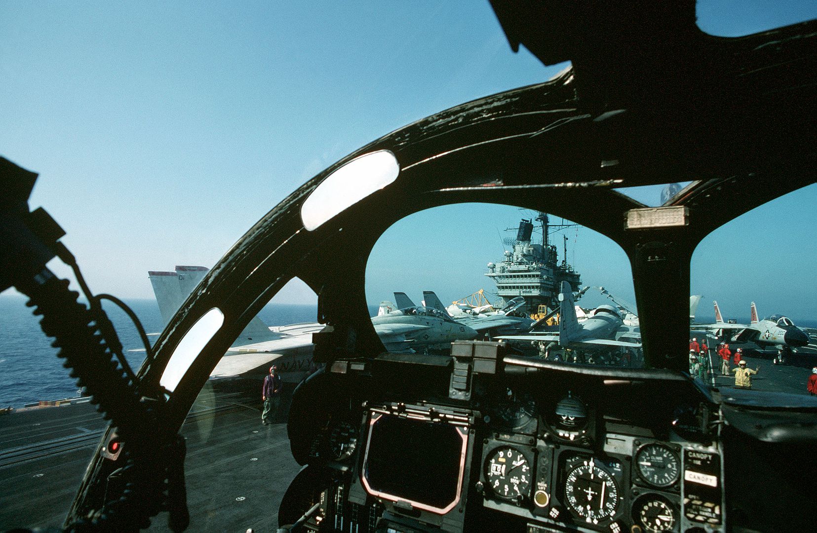 As Seen From The Cockpit Of An Attack Squadron 176 KA 6D Intruder Aircraft A Plane Director Guides A Pilot Across The Crowded Flight Deck Of The Aircraft Carrier USS FORRESTAL