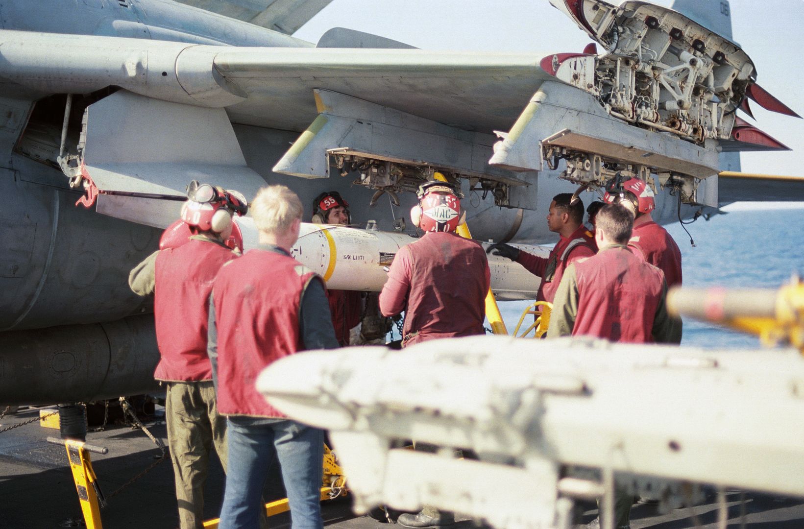 Aviation Ordnancemen From Attack Squadron 55 Prepare To Unload An AGM 84A Harpoon Missile From An A 6E Intruder Aircraft On The Flight Deck Of The Aircraft Carrier USS CORAL SEA
