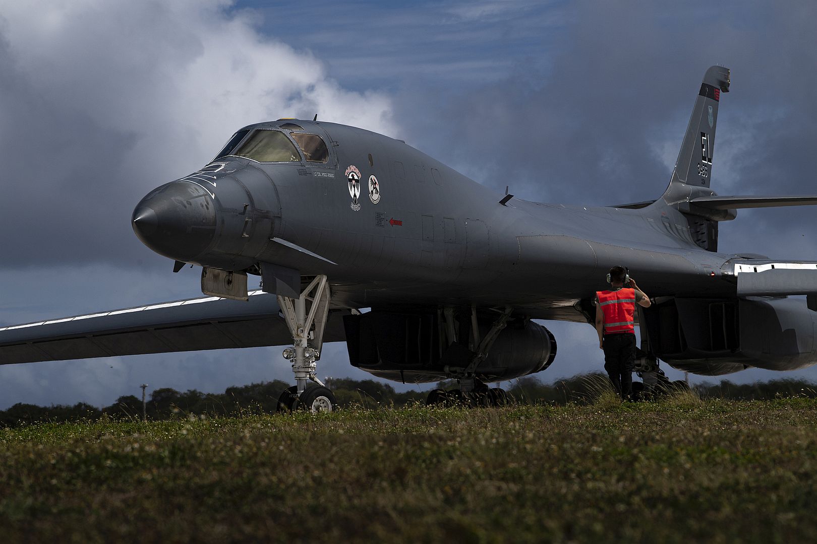 1B Lancer Attached To The 34th Bomb Squadron South Dakota Taxis Past An Aircraft Director Before Take Off At Anderson Air Force Base Guam June 8 2022 1B Lancer Attached To The 34th Bomb Squadron South Dakota Taxis Past An Aircraft Director Before Take Off At Anderson Air Force Base Guam June 8 2022