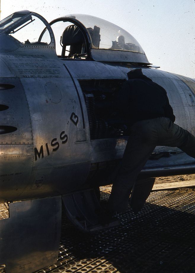 Close Up Of A Technician Working On The Ammunition Bay Of A North American F 86E Sabre Miss B Sn 50 602 Cn 170 24