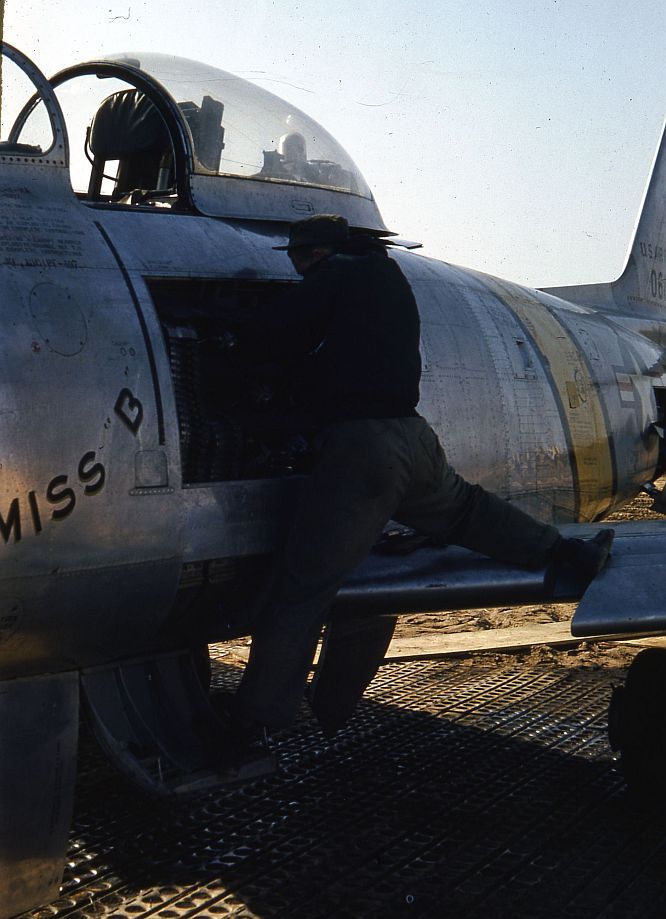 Close Up Of A Technician Working On The Ammunition Bay Of A North American F 86E Sabre Miss B Sn 50 602 Cn 170 24 1