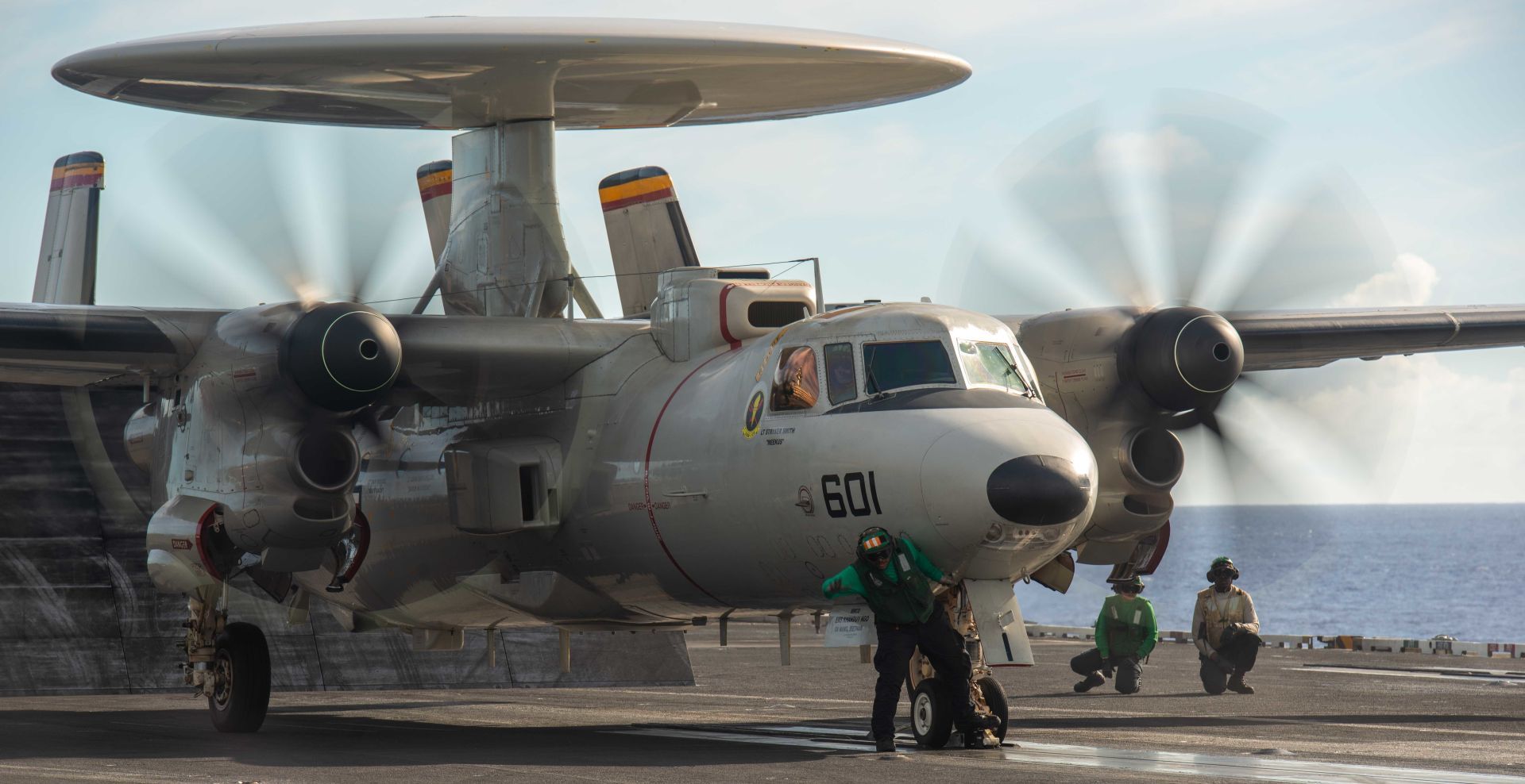 2D Hawkeye Attached To The Tigertails Of Airborne Early Warning Squadron 125 Into A Catapult Shuttle Aboard USS Ronald Reagan
