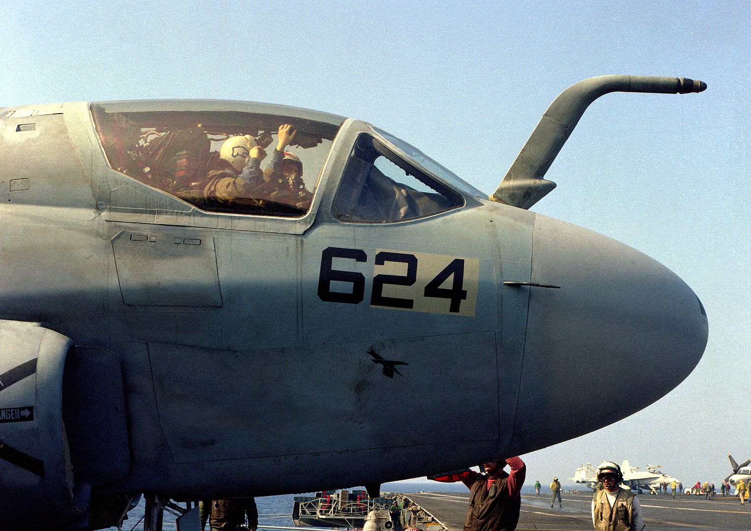 6B Prowler Flight Crew Wait For Flight Deck Crewmen To Complete A Preflight Check Aboard The USS CORAL SEA During Operations Near Libya
