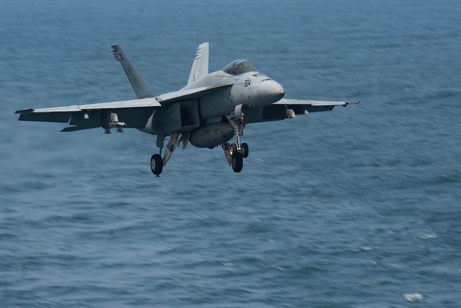 18E Super Hornet Fighter Jet Attached To The Royal Maces Of Strike Fighter Squadron 27 Prepares To Land On The Flight Deck Of Aircraft Carrier USS Ronald Reagan