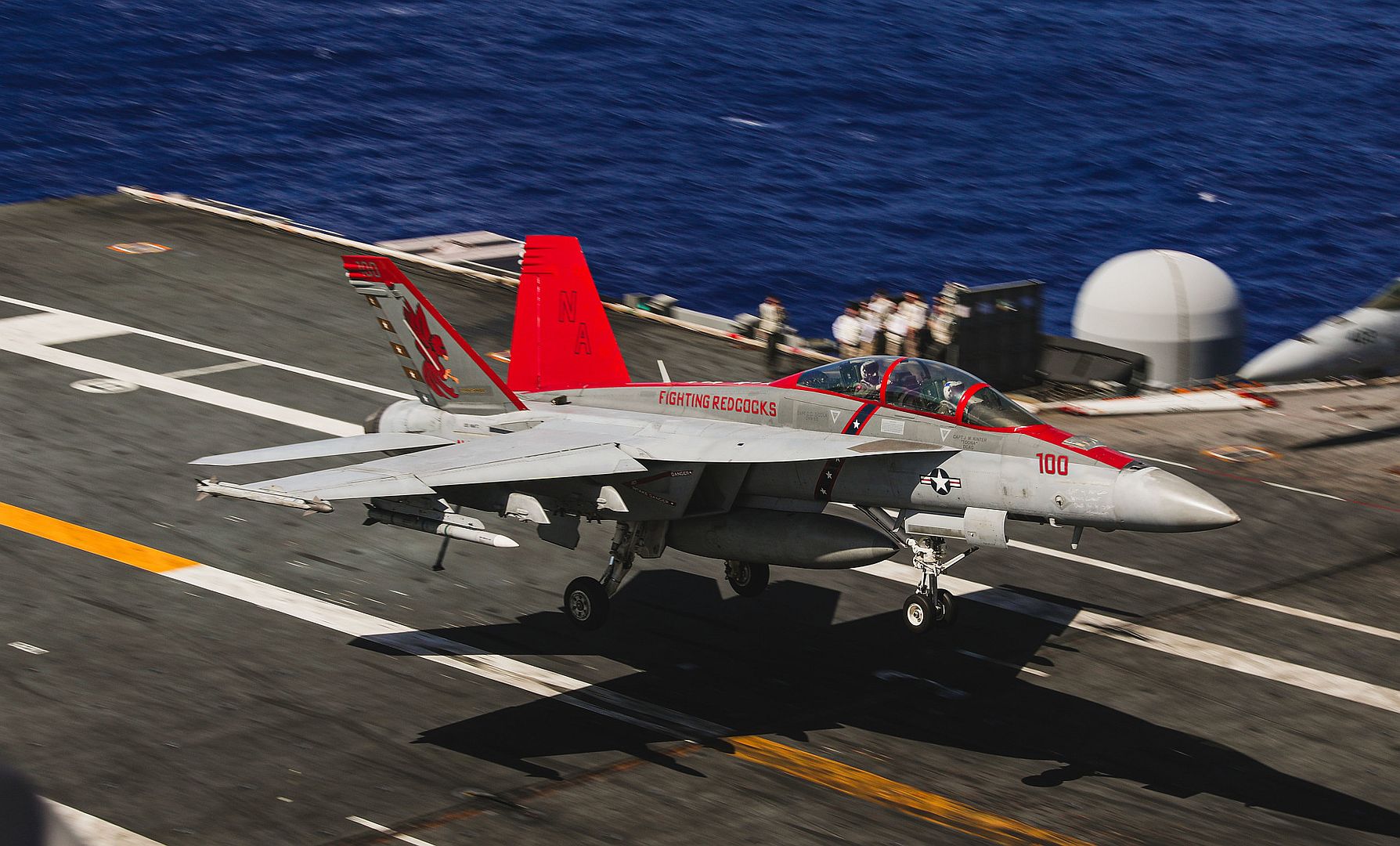 18F Super Hornet From The Fighting Redcocks Of Strike Fighter Squadron 22 Makes An Arrested Landing On The Flight Deck Of The Aircraft Carrier USS Nimitz