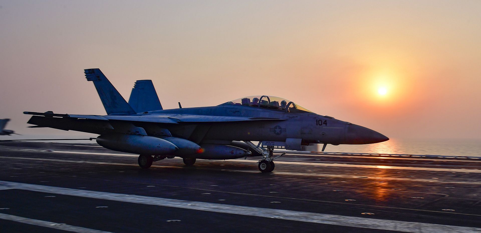 FA 18F Super Hornet From The Fighting Redcocks Of Strike Fighter Squadron VFA 22 Makes An Arrested Gear Landing On The Flight Deck Aboard The Aircraft Carrier USS Nimitz