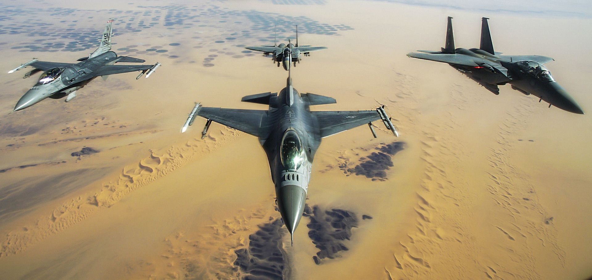 F 16 Fighting Falcons Assigned To The 77th Expeditionary Fighter Squadron Fly In Formation With Two Royal Saudi Air Force F 15E Strike Eagles 1