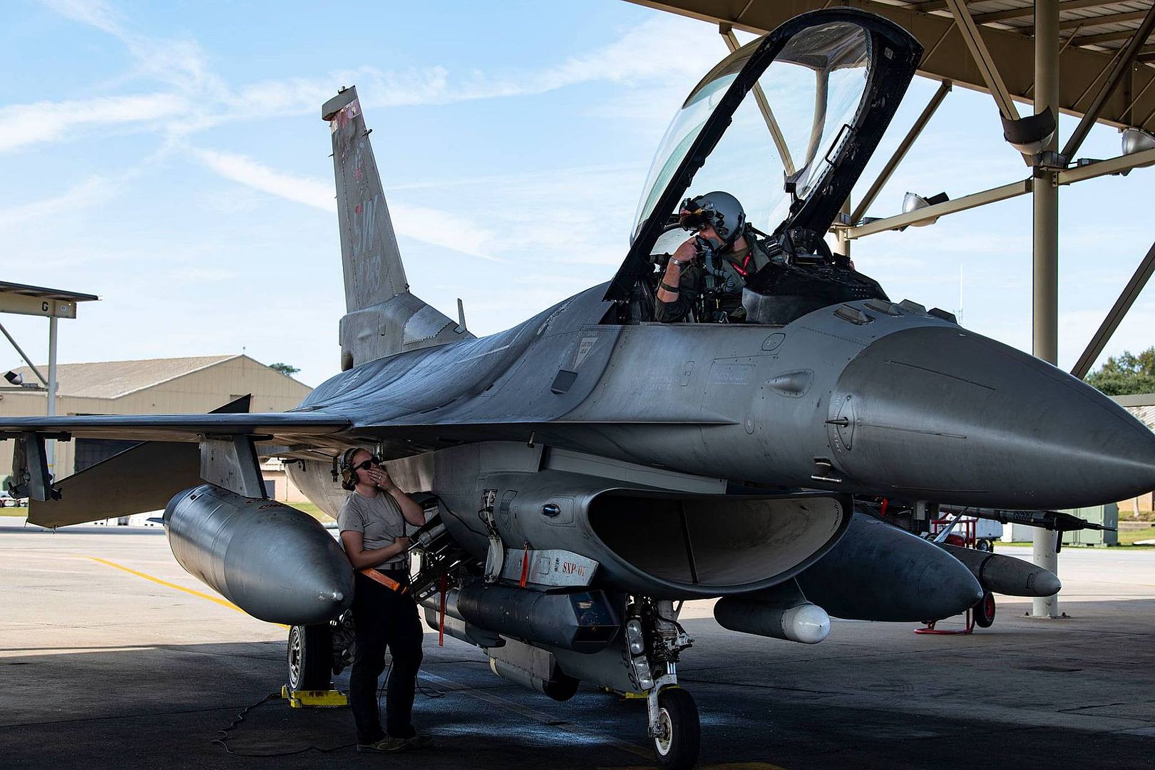 F 16 Viper Pilot Speaks Into A Headset To Airman 1st Class Makayla Weimer 79th Fighter Generation Squadron