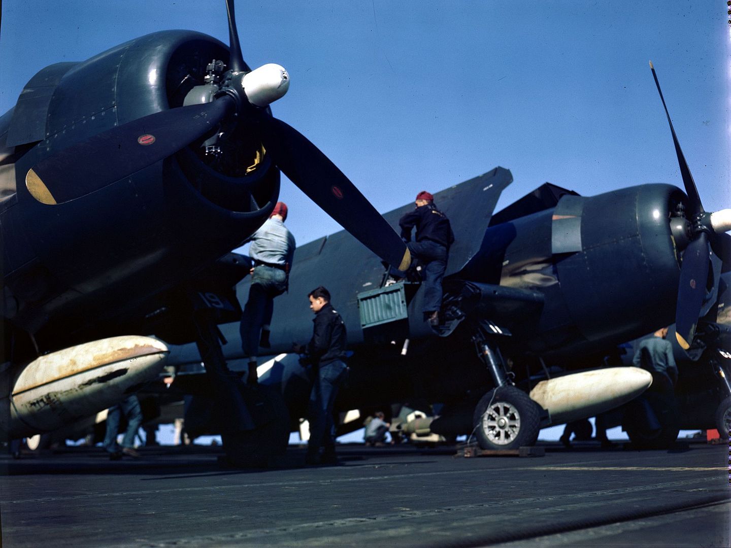 Ground Crewmen Check Hellcats On Carrier Flight Deck Before Takeoff Time