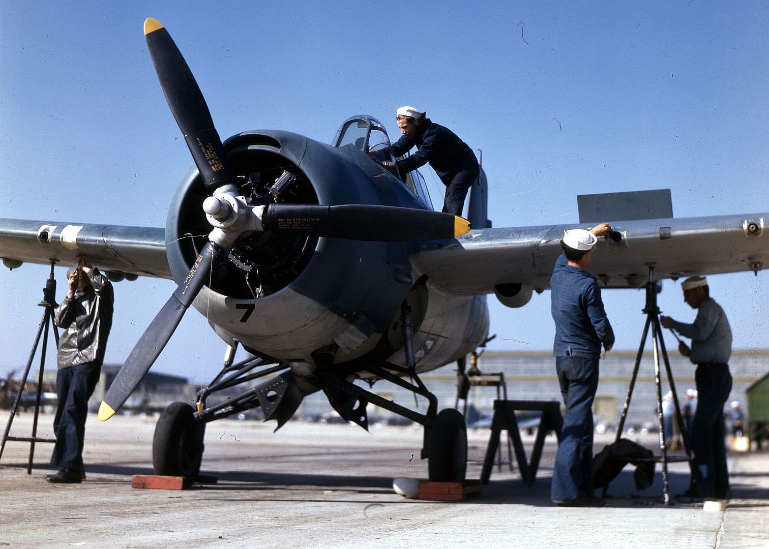 Ground Crewmen Work On F4F At Naval Air Station