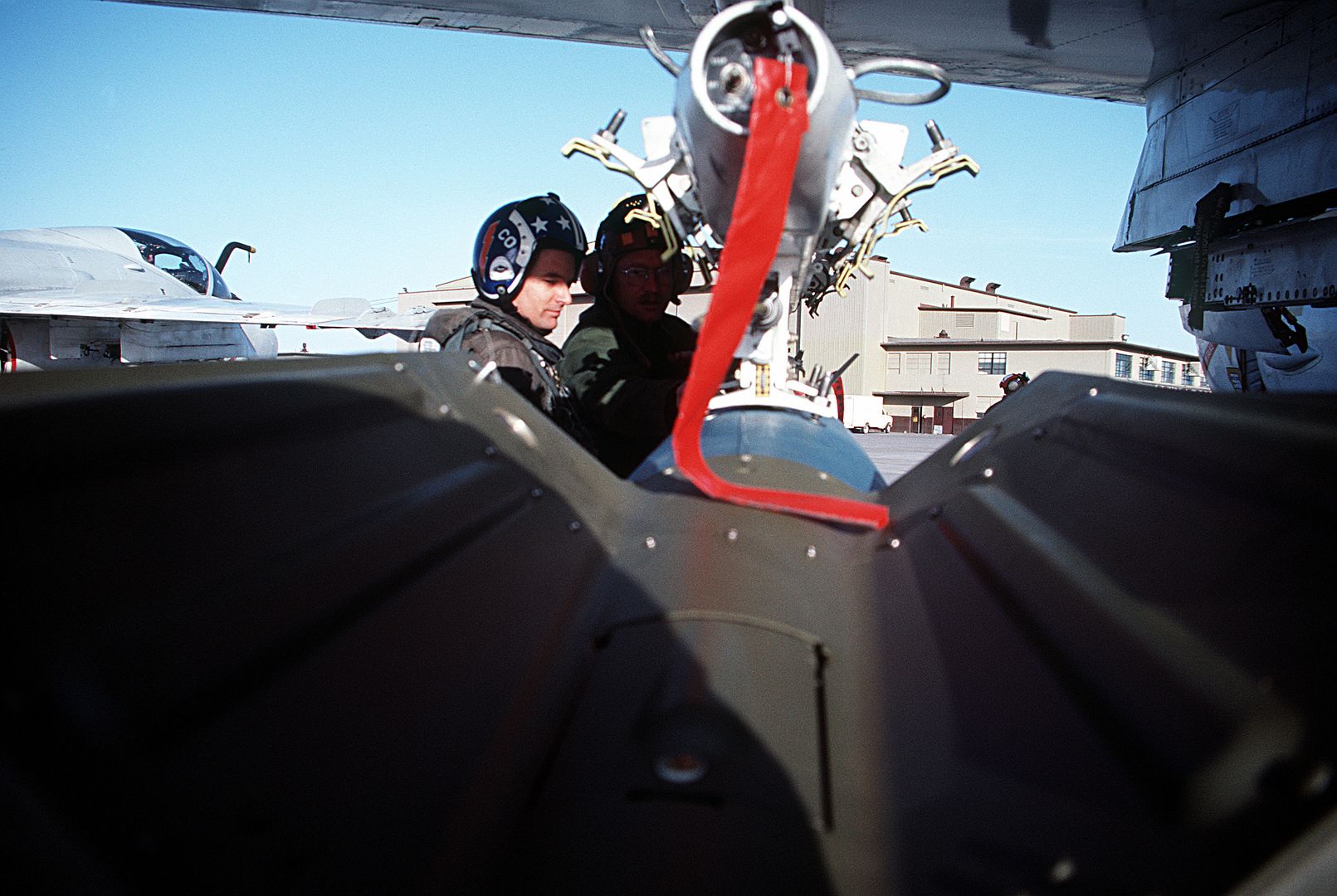 Ground Crewman Prepare To Load A Bomb Onto The Pylon Of An A 6E Intruder Aircraft From Carrier Air Wing Six