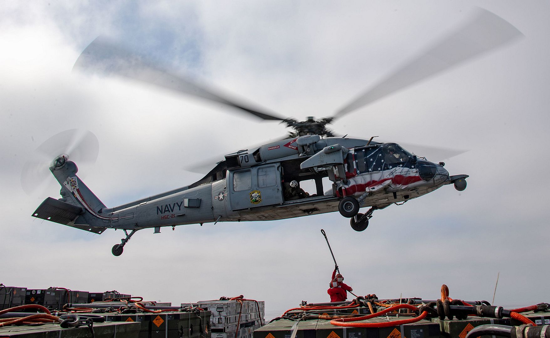 MH 60S Seahawk Attached To Helicopter Sea Combat Squadron 21 Lifts Ordnance From The Flight Deck Of Amphibious Assault Ship USS Boxer